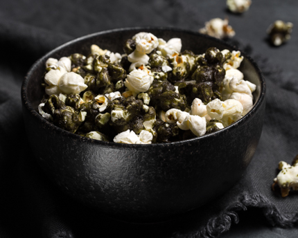 Maïs soufflé au caramel noir au matcha dans un bol noir