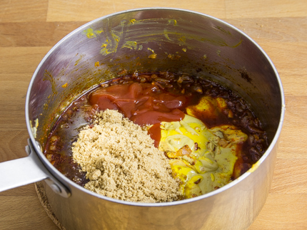 Cassonade Foncée Redpath®, ketchup, moutarde de Dijon, oignons et épices dans une casserole