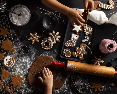 Assortiment de biscuits au pain d’épice à l’emporte-pièce sur une grille de refroidissement sur le comptoir, avec plaque contena